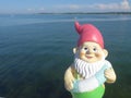 Funny garden gnome with floating ring seaside