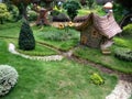 Dwarf house with path a small tree and small bushes