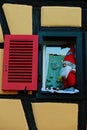 A dwarf Santa Claus toy decorating a window in a house of Alsace, France Royalty Free Stock Photo