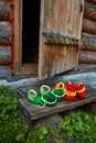 The dwarfs came home and took off his shoes at the threshold of an old wooden house Royalty Free Stock Photo