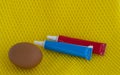 Dye for Easter eggs. paint in tubes and a chicken egg on a bright yellow background Royalty Free Stock Photo