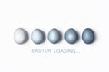 Dyed blue gradient Easter eggs row, Easter loading concept. Royalty Free Stock Photo