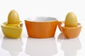 Dyed Ester eggs in colorful ceramic egg cups