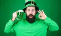 Dyed green traditional beer. Patricks day party. Alcohol beverage. Symbol of Ireland. Man bearded hipster drink beer