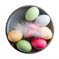 Dyed multi-colored eggs in gray bowl isolated on white background. Top view. Happy Easter Royalty Free Stock Photo
