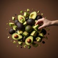 Hand Picking Floating Fresh Avocado Pieces on Brown Background Royalty Free Stock Photo