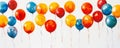 A dynamic array of balloons in vibrant primary colors, floating in a whimsical pattern against a