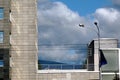 modern building and dynamic blue sky with white clouds. blurry green mountain Royalty Free Stock Photo