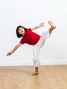 Dynamic child enjoying fighting tai chi, kung fu or taekwondo Royalty Free Stock Photo