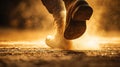 Dynamic close-up of a cowboy boot kicking up dust at sunset Royalty Free Stock Photo