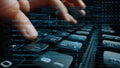 Close-Up of Hands Typing on Keyboard with Motion Blur and Digital Code Overlay for Technology and Programming Themes Royalty Free Stock Photo