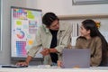 Dynamic Collaboration. Young professionals discussing project ideas in modern workspace. Royalty Free Stock Photo