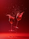 Dynamic Collision of Red Wine Glasses with Vivid Splashes Against Dark Red Background Royalty Free Stock Photo