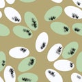 Seamless pattern of white and green textured ovals on an olive background for textile.