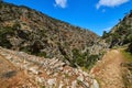 Dynamic composition of typical Greek landscape, hills, fresh spring greenery, paved paths crossing. Avlaki gorge of