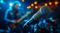 Dynamic concert vibes with microphone and blurred musicians under vibrant stage lights Royalty Free Stock Photo