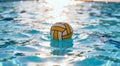 Vibrant Water Polo Ball Floating in Sunlit Pool Royalty Free Stock Photo