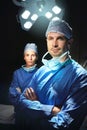 Dynamic doctoring duo. Cropped portrait of two doctors against a dark background. Royalty Free Stock Photo