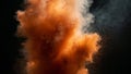 Dynamic explosion of vibrant orange powder creating abstract clouds and fine particle dispersion against a deep black background Royalty Free Stock Photo