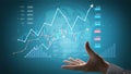 Dynamic Financial Data Visualization with Hand Gesture Representing Stock Market Trends and Graphical Analytics in a Royalty Free Stock Photo