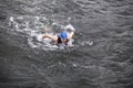 Dynamic and fit swimmer performing the butterfly stroke in dark ocean water Royalty Free Stock Photo