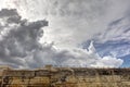 Dynamic HDR photo of cloudy skies and sun behind the clouds and historic city Valletta