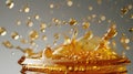 Dynamic honey splash with airborne droplets on a grey backdrop.