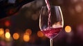 A dynamic image showing red wine being poured into a glass from a bottle. Assessing the quality of wine at a winery or drinking
