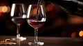 A dynamic image showing red wine being poured into a glass from a bottle. Assessing the quality of wine at a winery or drinking