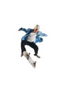 Dynamic image of teen boy in blue shirt and capo training, in motion, skateboarding isolated over white background