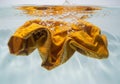 Yellow Fabric Submerged in Water, Bubbles and Texture, Clean Clothes Concept Royalty Free Stock Photo