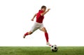 Dynamic image of young girl, football, soccer player in motion, dribbling ball isolated over white background Royalty Free Stock Photo