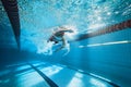 Dynamic image of young man, swimmer in motion, swimming freestyle stroke in pool, training. Royalty Free Stock Photo