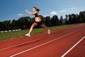 Dynamic image of a young woman running on a track