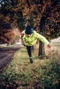 Dynamic jump of a former professional athlete into the grass near a forest road in the Czech Republic. A man jumps on his head