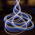 Dynamic light trails in blue and yellow create intricate, swirling patterns against a dar Royalty Free Stock Photo