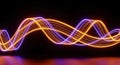 Dynamic Light Trails: Intertwined Orange and Purple Waves on Black Background Royalty Free Stock Photo