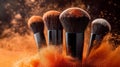 Dynamic Makeup Brushes with Exploding Orange Powder Royalty Free Stock Photo