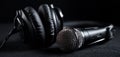The dynamic microphone and headphones on a sleek black background. AI generated image Royalty Free Stock Photo