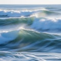 Dynamic ocean waves with whitecaps, captured in a soft, smooth appearance. The water appears deep Royalty Free Stock Photo