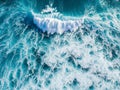 Dynamic overhead shot of a massive blue ocean wave cresting with foam Royalty Free Stock Photo