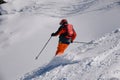 Dynamic photo of advanced skier downhill at the off piste area leaving fresh snow powder behind. Royalty Free Stock Photo