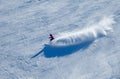 Dynamic photo of skier downhill in fresh snow on a sunny winter day at the Madonna di Campiglio Ski Resort.