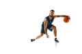 Dynamic portrait of professional basketball player honing skills with precision dribbling against white background. Royalty Free Stock Photo