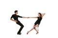 Dynamic portrait of young emotive dancers in black outfits dancing ballroom dance isolated on white background. Concept Royalty Free Stock Photo