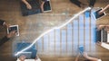 Business Professionals Analyzing Growth Data on Tablets and Laptops with Graphs and Charts on Wooden Table in Modern Royalty Free Stock Photo
