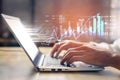 Hands Typing on Laptop with Digital Financial Data and Graphs Displayed, Representing Online Investing and Stock Market Royalty Free Stock Photo