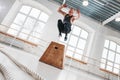 Dynamic shot of fit athlete jumping over cross box in fitness club Royalty Free Stock Photo