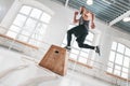 Dynamic shot of fit athlete jumping over cross box in fitness club Royalty Free Stock Photo