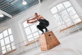 Dynamic shot of fit athlete jumping over cross box in fitness club Royalty Free Stock Photo